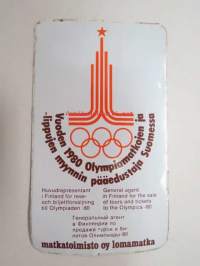 Matkatoimisto Oy Lomamatka - Vuoden 1980 Olympiamatkojen ja -lippujen myynnin pääedustaja Suomessa -tarra
