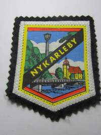 Nykarleby -kangasmerkki / matkailumerkki / hihamerkki / badge -pohjaväri musta