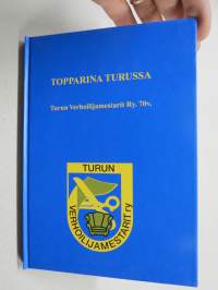 Topparina Turussa - Turun Verhoilijamestarit Ry. 70 vuotta  -historiikki
